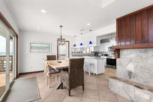a kitchen and dining room with a table and chairs at Sun 'n Surf in Inlet Beach