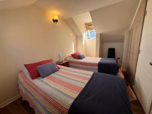 a room with two beds in a room with a lamp at Decher Apartment - Puerto Varas in Puerto Varas