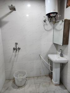 a bathroom with a toilet and a sink at Brown oak farms in Sohna