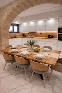 a kitchen with a large wooden table and chairs at 500 sqm Private Garden, Outdoor Kitchen, near Falasarna & Balos Beach in Falasarna