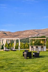 a group of chairs and a gazebo in a field at 500 sqm Private Garden, Outdoor Kitchen, near Falasarna & Balos Beach in Falasarna