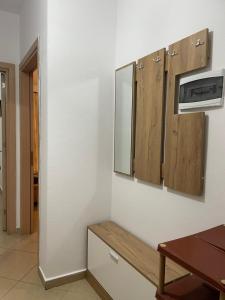 a kitchen with wooden cabinets and a wooden table at Endi Apartments 2 in Tirana