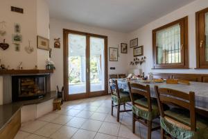 a dining room with a table and chairs and a fireplace at ROSSO DI SERA Bed & Breakfast in Tarcento