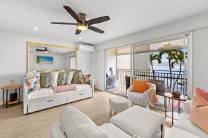 a living room with a bed and a balcony at Lahaina Roads 302 in Lahaina
