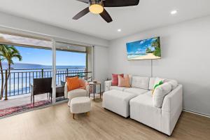 a living room with a couch and a ceiling fan at Lahaina Roads 302 in Lahaina +58 photos