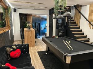 a billiard room with a pool table and stairs at Chambre de charme, sauna, jacuzzi,billard VIP, clim in Verviers