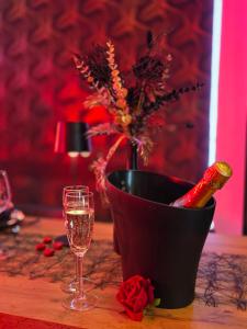 a bottle of champagne and a glass on a table at Chambre de charme, sauna, jacuzzi,billard VIP, clim in Verviers