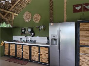 a kitchen with a refrigerator and a sink at Refugio cerca a Villeta in Petaqueros