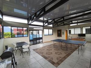 a large room with two ping pong tables in it at Tucan Apartment in Agua Azul