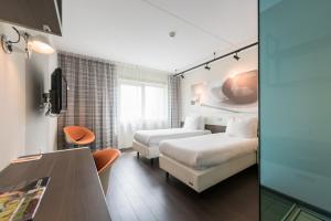 En eller flere senge i et værelse på Hotel Papendal