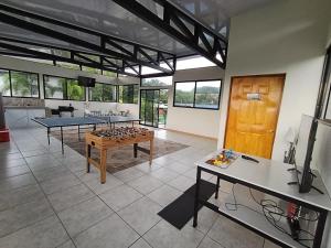 a living room with a ping pong table in it at Tucan Apartment in Agua Azul
