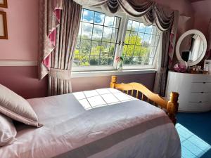 a bedroom with a bed in front of a window at CarMichael in Edinburgh +35 photos