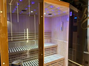 a sauna with purple lights on top of it at Chambre de charme, sauna, jacuzzi,billard VIP, clim in Verviers