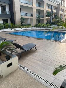 a swimming pool in the middle of a building at Embassy Gardens Studio Accra in Accra