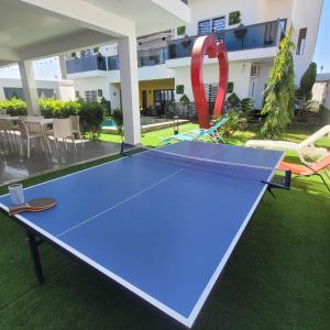 a ping pong table in the backyard of a house at Villa burj in Ngaparou