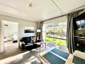 a living room with a couch and a table at Mt Dobson Motel in Kimbell