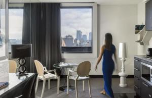 a woman standing in a kitchen looking out the window at Elli Prahran in Melbourne