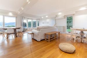 a living room with a couch and a table at Villa Bista Eder in Hondarribia