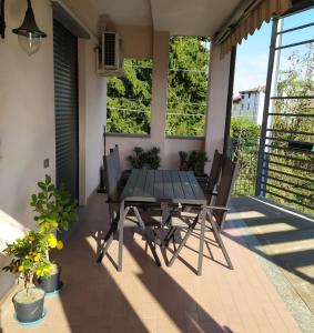 a patio with a black table and chairs at Bright apartment between Como and Milan in Lurago Marinone