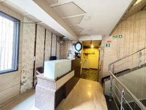 a hallway with a staircase in a building at Hotel Falcon Ulhasnagar by Hotelist in Kalyan +22 photos