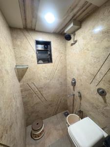 a bathroom with a shower with a toilet in it at Hotel Falcon Ulhasnagar by Hotelist in Kalyan