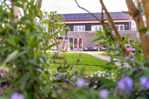 a house with a garden in front of it at De Vlindertuin in Nes +62 photos