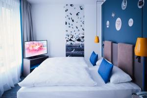 Ein Bett oder Betten in einem Zimmer der Unterkunft Vienna House Easy by Wyndham Berlin Prenzlauer Berg