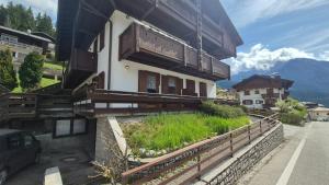 a building with a balcony on the side of it at Saroio B in Auronzo di Cadore
