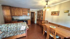 a living room with a couch and a wooden table at Saroio B in Auronzo di Cadore +13 photos