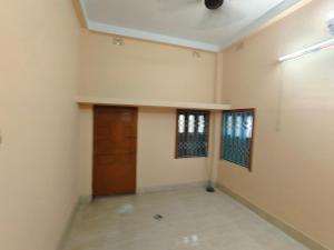 an empty room with a door and a hallway at Swapnanir in Howrah