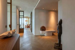 a living room with a bench in the corner of a house at O'Ciel 24 - Exceptional 24th floor Residence - Ostend in Ostend +79 photos