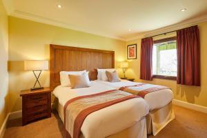 a hotel room with two beds and a window at Host & Stay - Beech Lodge in Belton
