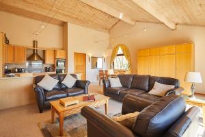 a living room with leather couches and a table at Host & Stay - Beech Lodge in Belton +23 photos