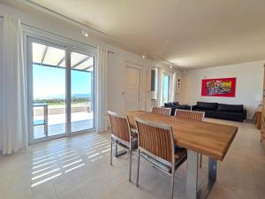 a living room with a wooden table and chairs at Villas By George in Afiartis