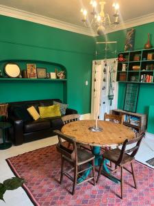 a living room with a table and a couch at Mansefield Rooms in Lockerbie