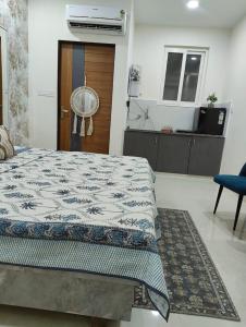 a bedroom with a bed and a door with a fan at Cozy Cove in Jaipur +18 photos