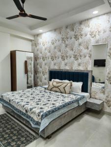 a bedroom with a large bed with a blue headboard at Cozy Cove in Jaipur