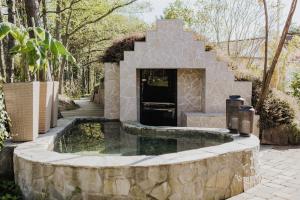 a pool of water in a stone fountain in a yard at Longbeach Life in Falkenberg