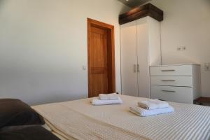 a bedroom with two towels on a bed at Villas By George in Afiartis