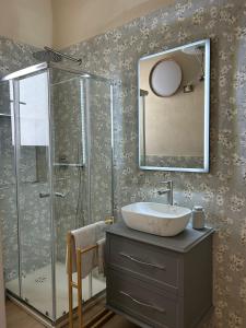 a bathroom with a sink and a glass shower at Luce di Mare in Quartu SantʼElena