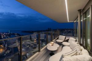 a balcony with a view of a city at night at O'Ciel 24 - Exceptional 24th floor Residence - Ostend in Ostend
