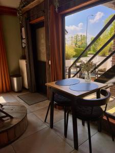 a table and chairs in a room with a balcony at Spoor 2 met Wellness in Nieuwe Vaart