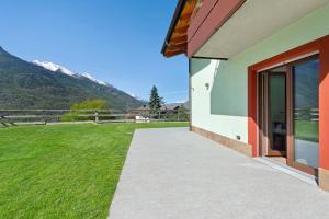 a walkway next to a house with a grass field at Appartamenti Suly 2 - Cir0083 in Saint Vincent