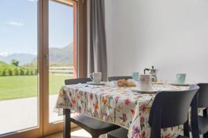 a dining room table with a tablecloth on it with a view of a window at Appartamenti Suly 2 - Cir0083 in Saint Vincent
