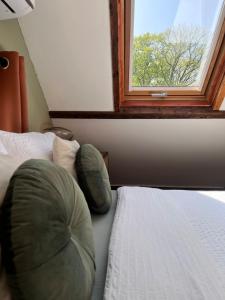 a bedroom with a bed and a window at Spoor 2 met Wellness in Nieuwe Vaart