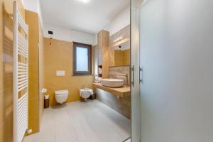 a bathroom with a sink and a toilet and a sink at Appartamenti Suly 2 - Cir0083 in Saint Vincent +8 photos