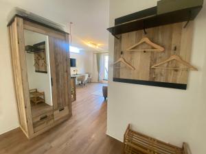 a room with a mirror and a wooden wall at Jena Ferienwohnung Campusblick in Jena
