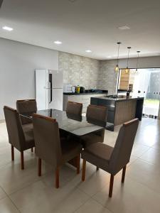 a kitchen with a dining room table and chairs at Sobrado amplo com churrasqueira in Rio Verde