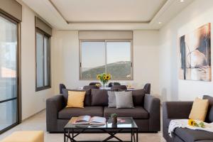 a living room with a couch and a table at Brummana Views in Broummana