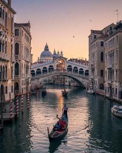 a gondola in a canal in front of a bridge at Casa sulla Laguna CASTELLO in Venice
